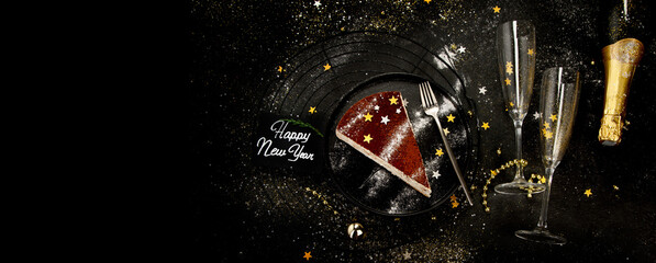 Christmas cake slice on dark background.