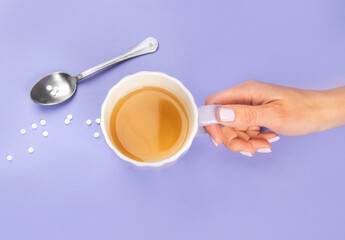 Tea cup with suagr substitute on color background.