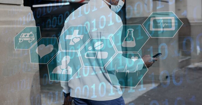 Digital illustration of man wearing a face mask over medical icons