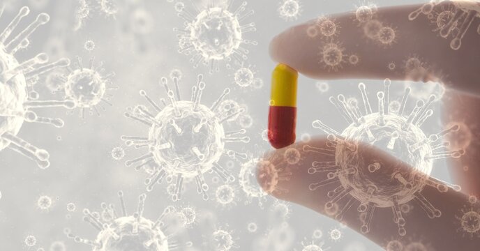 Digital illustration of person holding a medical pill over macro Coronavirus Covid-19 cells floating
