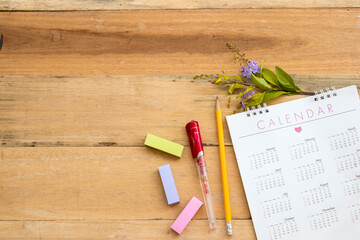 post it note with calendar planner for work arrangement flat lay style on background wooden