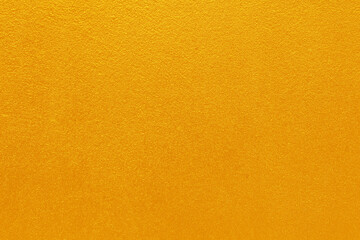 Gold or yellow paint on cement wall texture  background.