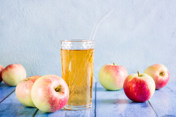 Fresh apple juice in a glass and fruits on the table. Homemade drinks.