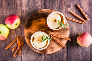 Natural apple cider with cinnamon in glasses on the table. Homemade drinks. Top view