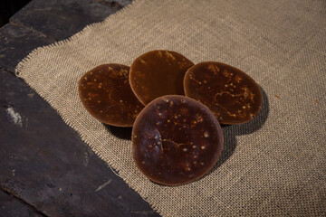 Round organic palm sugar traditionally processed by rural communities in Indonesia, photographed in the kitchen of one of the villagers