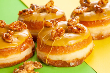 Walnut flavoured caramelised gourmet brioche doughnuts closeup.