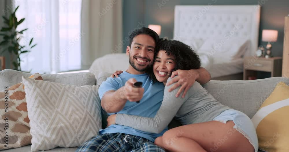 Poster Love, couple and television with a man and woman on the sofa to relax while watching tv in their home. Happy, smile and excited with a young male and female sitting in the living room together