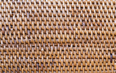 The background of brown rattan weaving is a detailed work. Exquisite that requires skilled technicians because it takes a long time to produce. Technicians need patience. abstract art background.