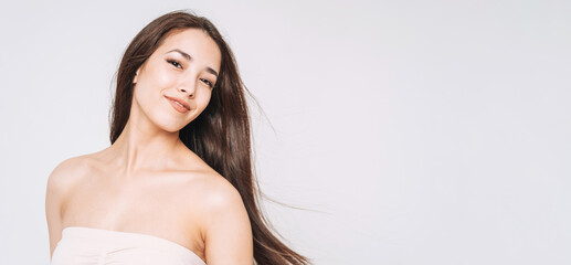 Beauty portrait of happy young beautiful asian woman with healthy dark long hair in top bando on...