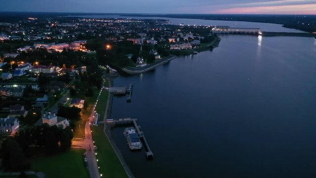 Scenic general aerial view of lighted Russian town of Uglich on banks of Volga River on summer evening, Yaroslavl Oblast. High quality 4k footage