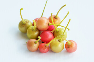Muntingia calabura fruit is red, round and sweet. shaped like a cherry on a white background this fruit is very rich in benefits