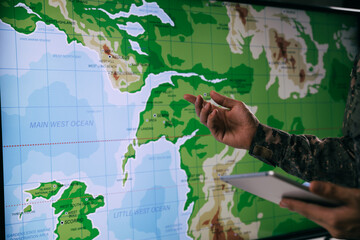 Hand of soldier pointing to map on electronic screen, Patrolling operation, Target enemies with satellites.