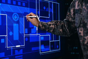 Hand of soldier pointing to building plan management, Paving a path on electronic screen.