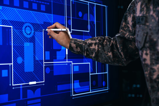 Hand of soldier pointing to building plan management, Paving a path on electronic screen.