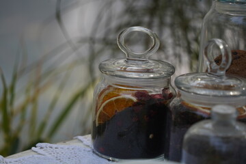 Dishes with spices, dried fruits and cookies on the garden table.