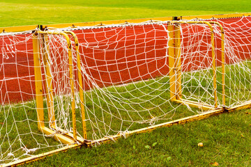 Small football goals lined up next a running track