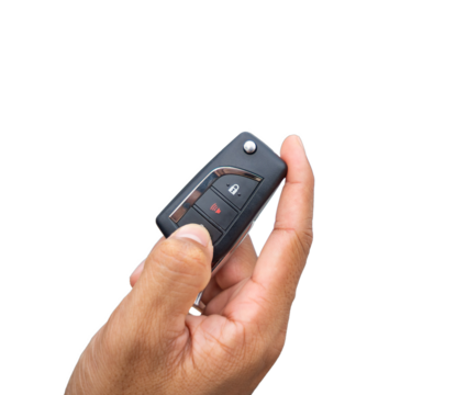 Hand pressing the button on the remote to lock or unlock the car with the remote control.