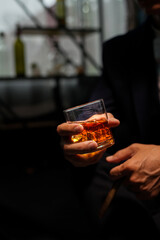 Closeup businessmen holding a glass of whiskey