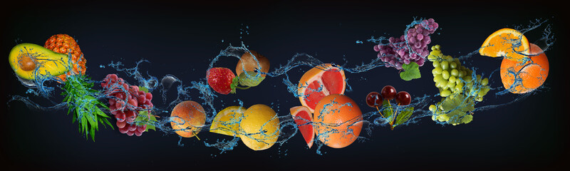 Fototapeta na wymiar Panorama with fresh fruits in the water - orange, grapes, cherries, grapefruit, lemon, pear, strawberry, kiwi, pineapple, avocado, a very tasty dessert for Halloween, Christmas and New Year