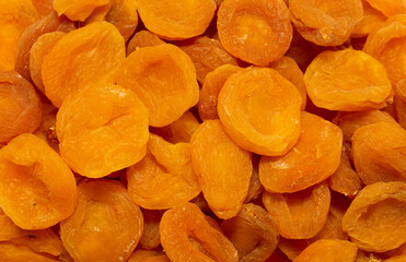 Dried apricots close up as a background. Heap of dried apricots on a white background.