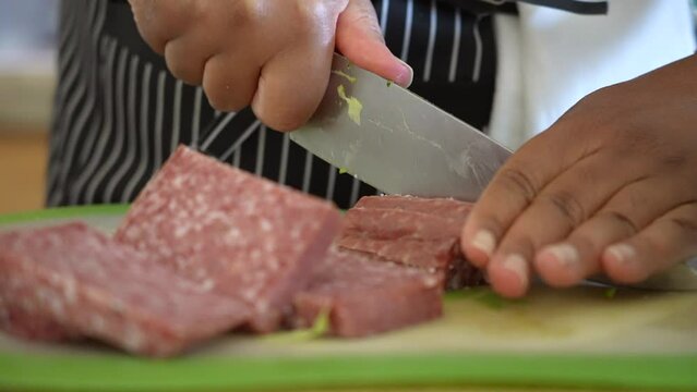 Cutting and slicing salami to serve over antipasto chopped salad - ANTIPASTO SALAD SERIES