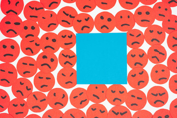 Creative flat lay layout made of paper faces and sticker about being surrounded by bad scowling...