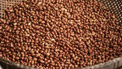 Plenty of roasted peanuts, in a tray, ready for baking.