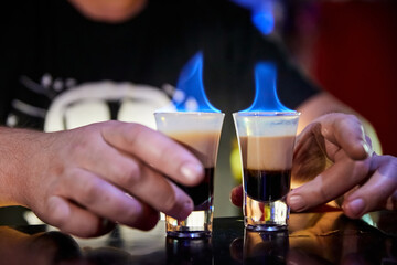 The bartender prepared burning shots