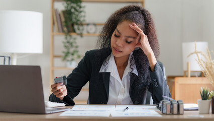 Stressed Asian business woman worry with many document on desk at office