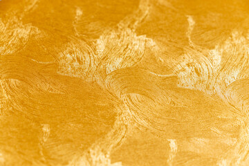 滑らかな曲線模様のある金色の壁紙