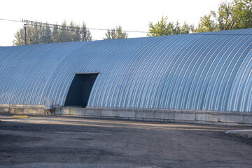 Large long arched stainless steel hangar with rolling gates