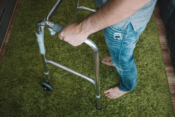 sick person moves with the help of special walkers. Problems with the musculoskeletal system. The...
