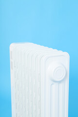 Modern white electric heater on blue background
