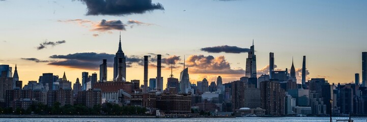 Panoramic view of waterside buildings and towers of NYC at sunset