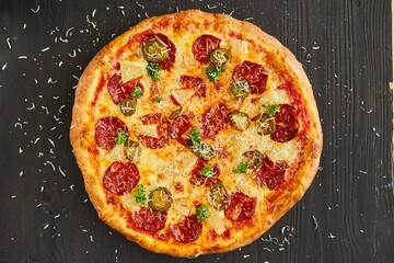 Pasta with salami, olives and pineapples. Food from the chef in a restaurant or cafe.