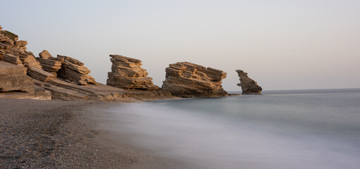 long exposure of rocks, beach and the sea on triopetra beach on the greek island crete