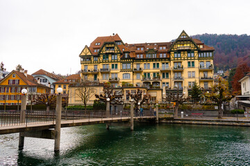 Nice view along Aare lake and old town of Thun during autumn , winter cloudy day : Thun , Switzerland : December 2 , 2019