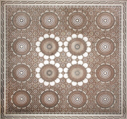 Ancient carved floral ornament in the Moroccan style. Square bas-relief with decorative element in arabic style