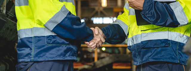Caucasian factory engineer talking and shaking hands on business cooperation agreement. Successful...