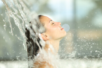 Woman under water jet in spa breathing - 531608915