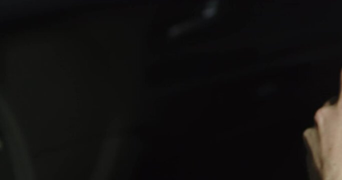 Police officer in the field, communicating with colleagues via radio in a police car.