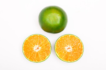 fresh orange fruits and slices isolated on a white background