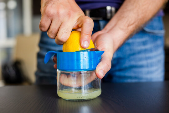 Man Squeezing Lemon Juice Close Up