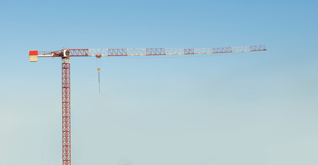 Tower crane on blue sky, front view