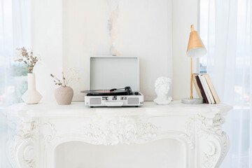 Record player with vinyl disc on table in room