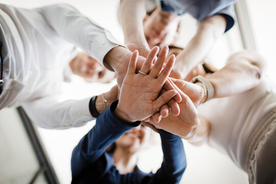 Business people stacking their hands together