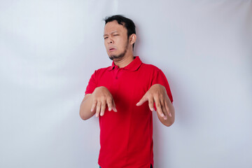 Attractive Asian man with hand gesture pose rejection or prohibition with copy space