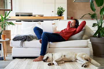 Businessman and dog relaxing in living room