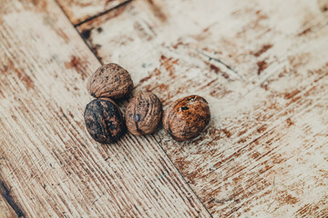 Bunch or fresh raw walnuts on a wooden background
