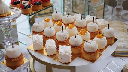 Catering Delicious Sweet Candy Bar Wedding. Stylish candy bar at the wedding reception. Sweet cakes and candies with muffins. Preparation for the event. Beautiful festive decoration evening party.